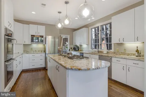 a living room with furniture potted plant and a large window