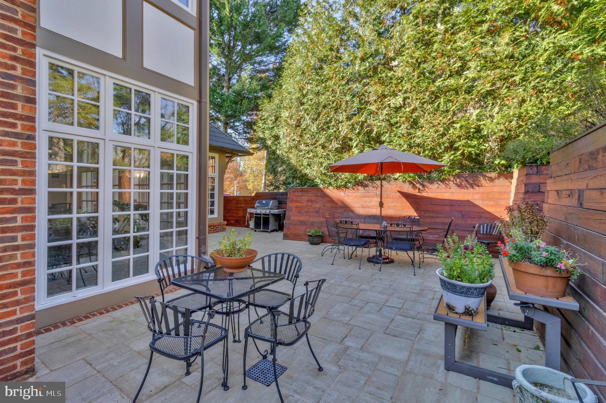 1655 Kalmia Road Northwest Washington, DC 20012 - Photo 65 of 71 a view of a patio with a table and chairs under an umbrella