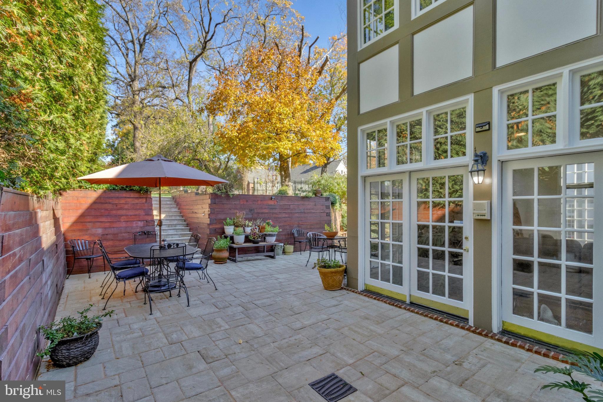 1655 Kalmia Road Northwest Washington, DC 20012 - Photo 67 of 71 a view of a patio with table and chairs under an umbrella