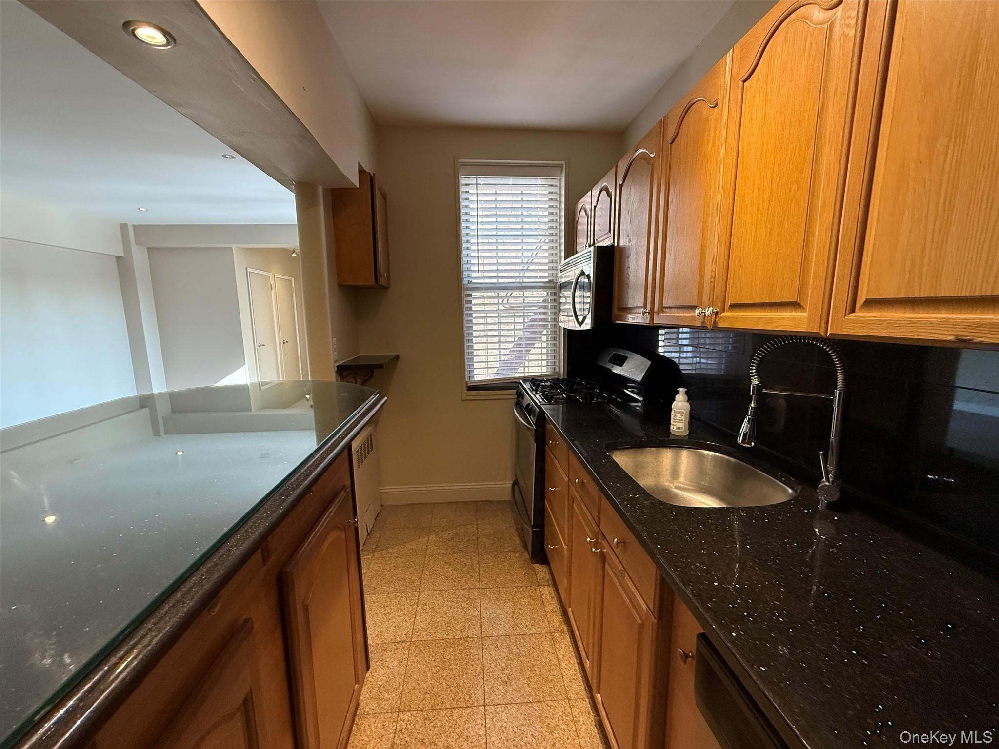 796 Bronx River Road, Unit B38 Bronxville, NY 10708 - Photo 9 of 31 a kitchen with granite countertop sink and cabinets