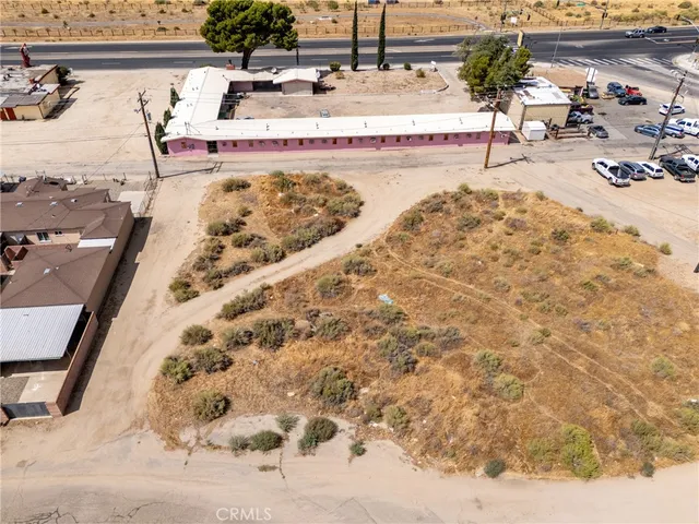an aerial view of a house with a yard and lake view