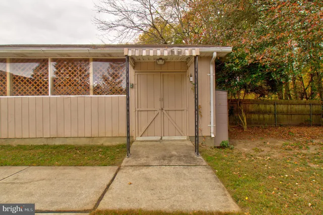 a view of a house with a wooden fence