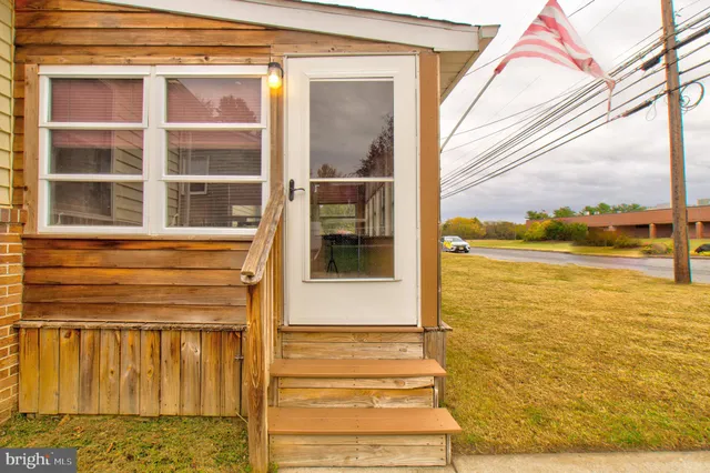 a view of a living room with furniture and window