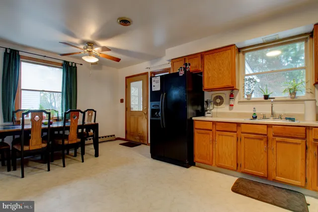 a view of a livingroom with furniture and chandelier fan