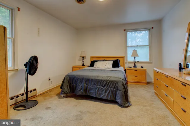 a bedroom with a bed and a dresser