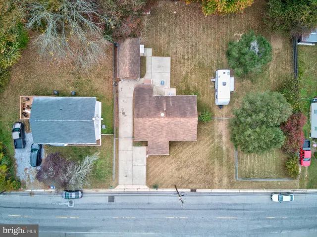 an aerial view of a house with garden space and sitting area