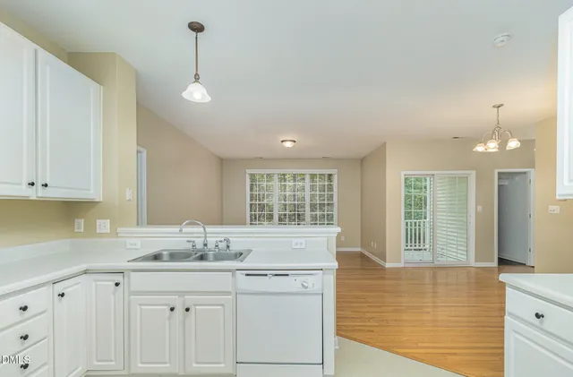 a kitchen with granite countertop white cabinets and a large window