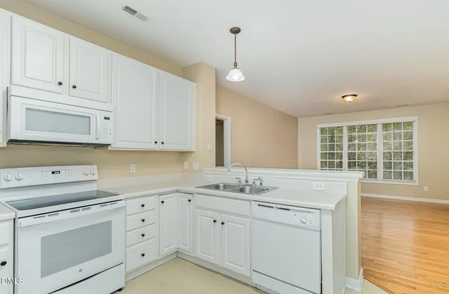 a kitchen with appliances cabinets and a sink