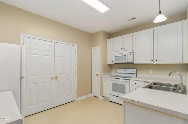 a kitchen with a sink cabinets and appliances