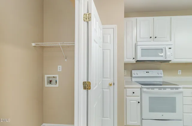 a view of a storage and utility room with washer and dryer
