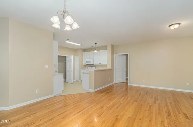 a view of a kitchen with a dishwasher cabinets and wooden floor