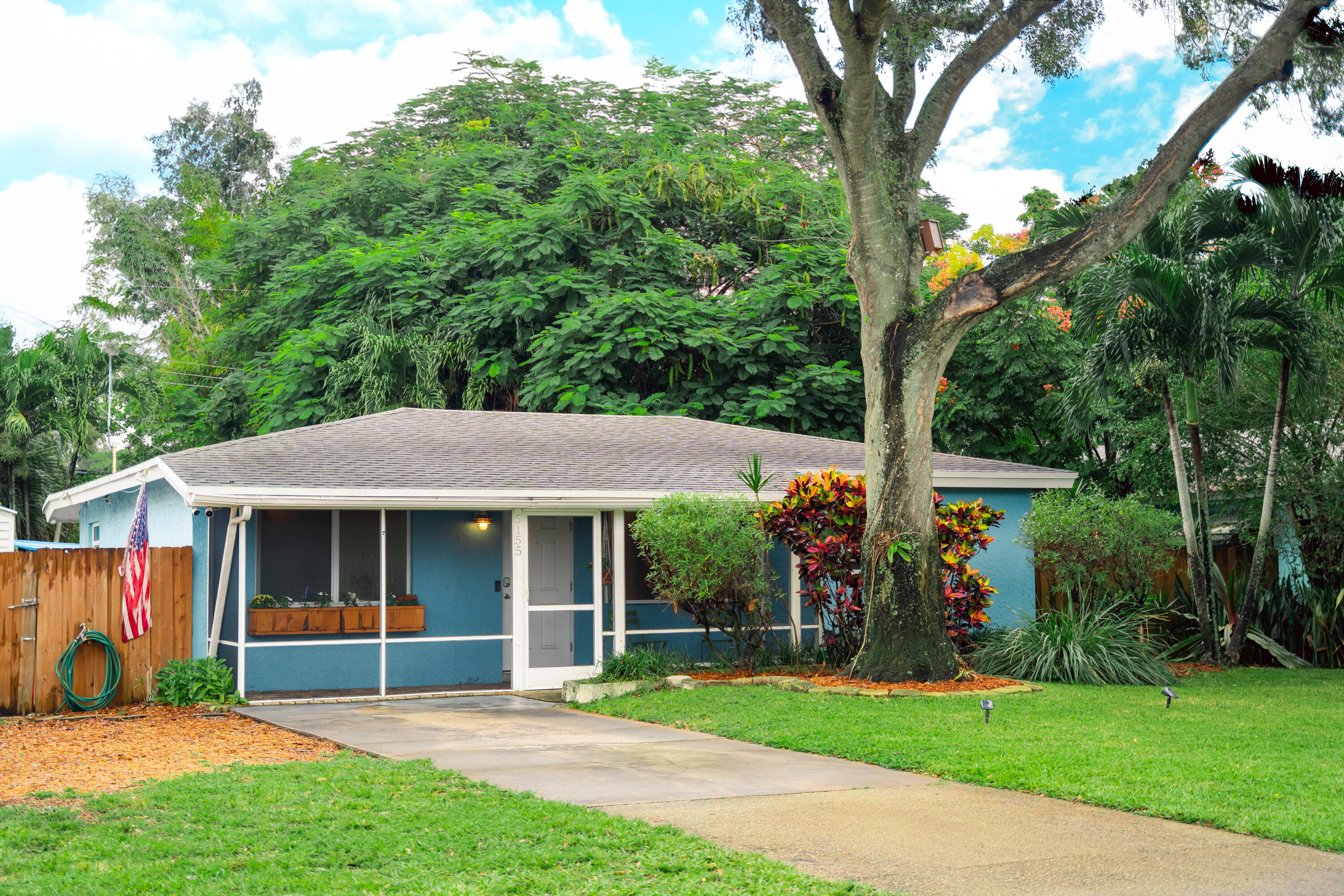 5155 Cleveland Road Delray Beach, FL 33484 - Photo 1 of 40 a view of house with a big yard and potted plants