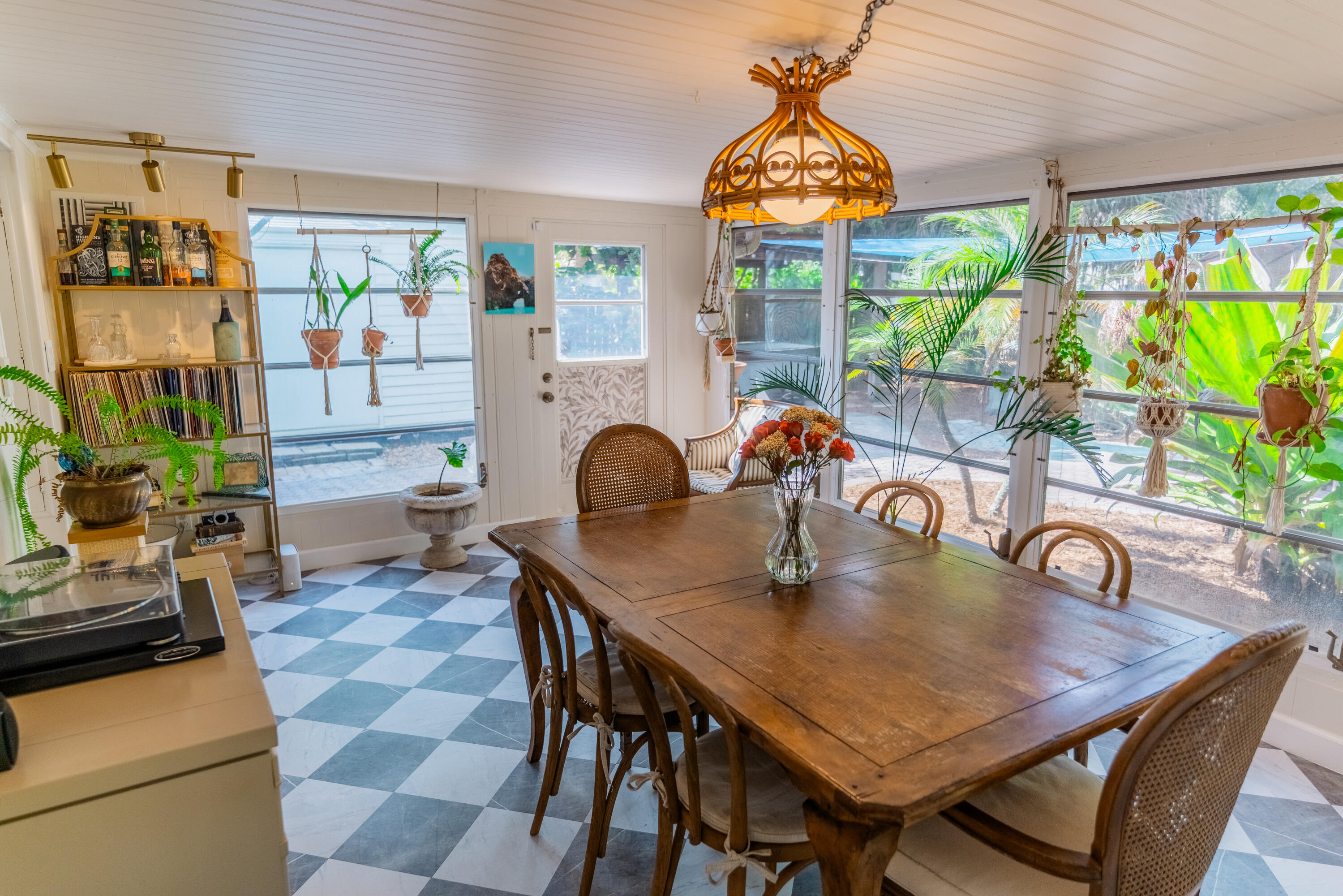 5155 Cleveland Road Delray Beach, FL 33484 - Photo 19 of 40 a dining room with furniture a large window and a chandelier