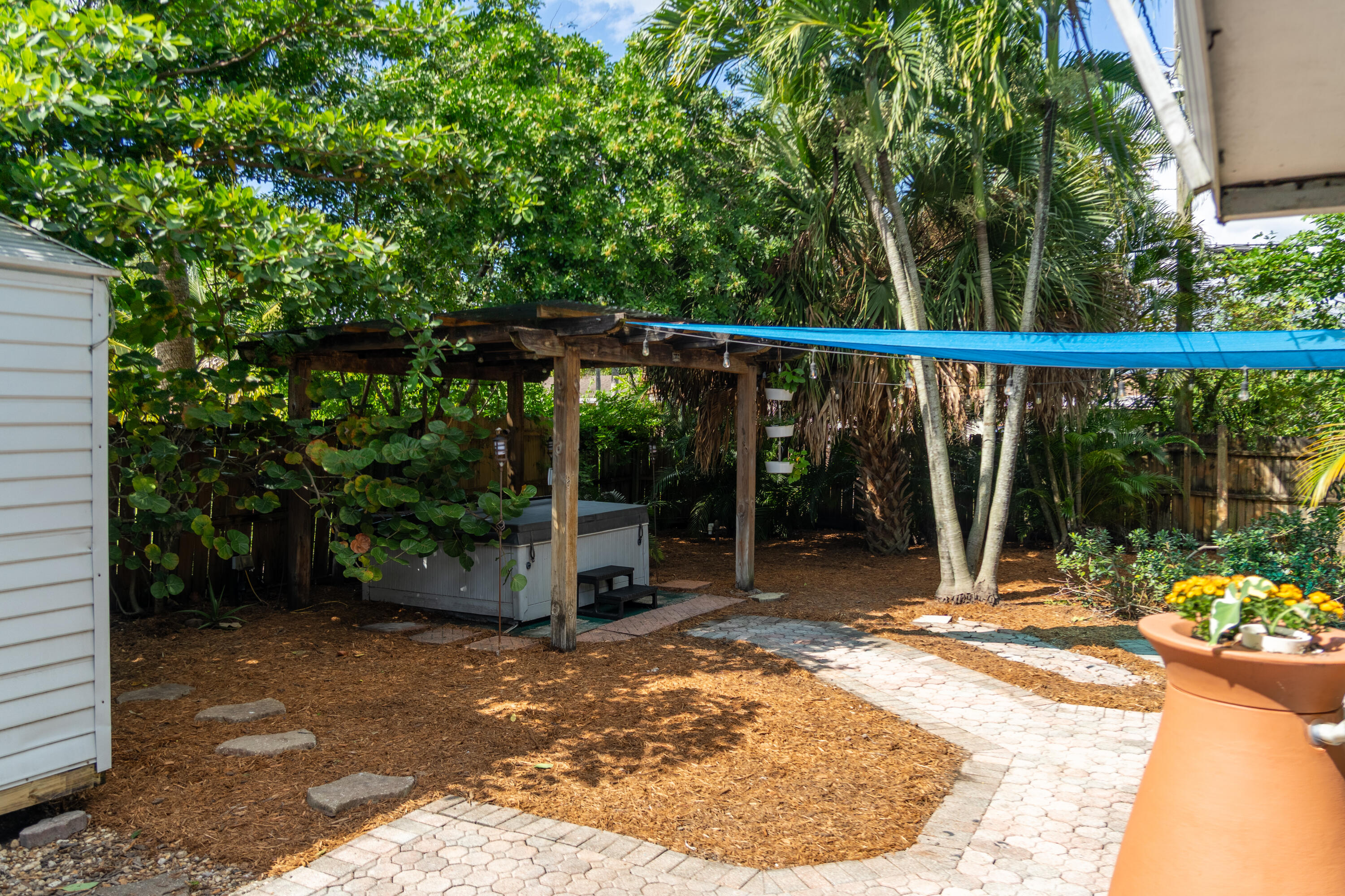 5155 Cleveland Road Delray Beach, FL 33484 - Photo 22 of 40 a view of a chair and tables in the patio