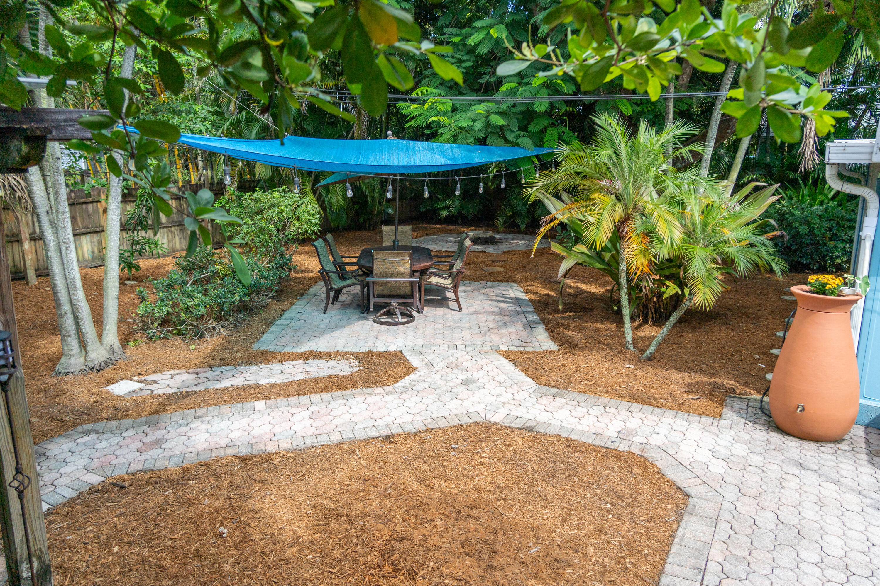 5155 Cleveland Road Delray Beach, FL 33484 - Photo 3 of 40 a view of a backyard with table and chairs under an umbrella