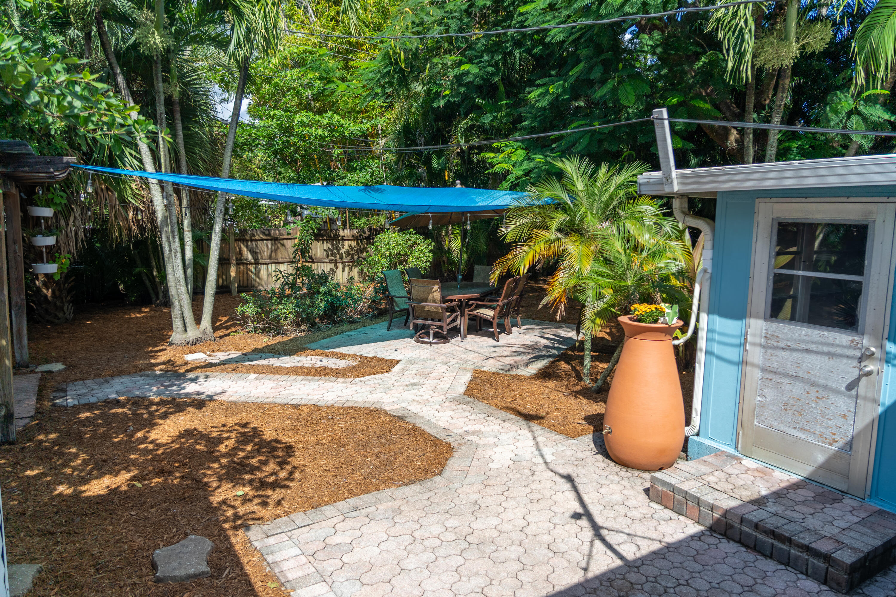 5155 Cleveland Road Delray Beach, FL 33484 - Photo 32 of 40 a view of a swimming pool with a patio and a yard