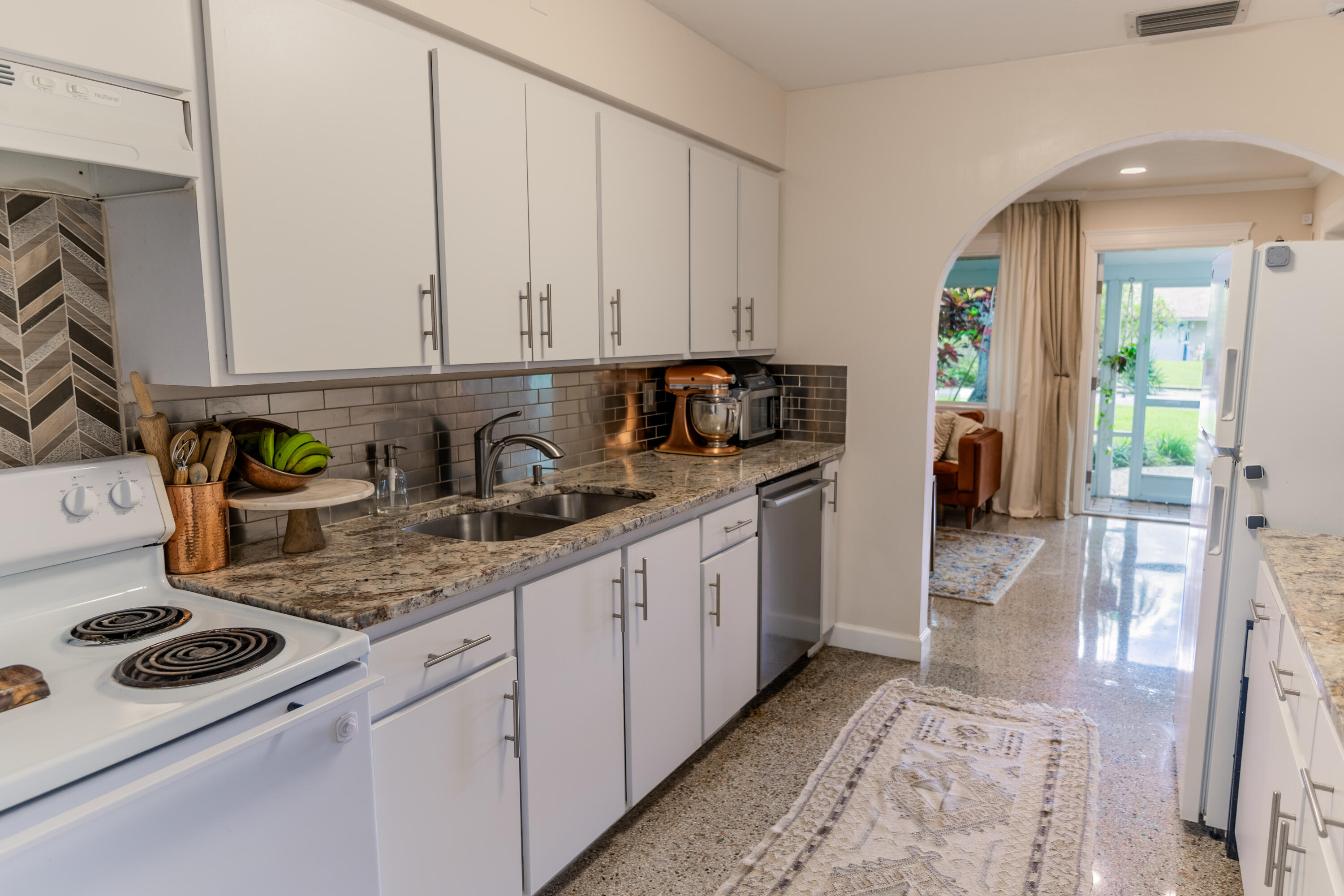 5155 Cleveland Road Delray Beach, FL 33484 - Photo 10 of 40 a kitchen with stainless steel appliances granite countertop a stove a sink and a white cabinets