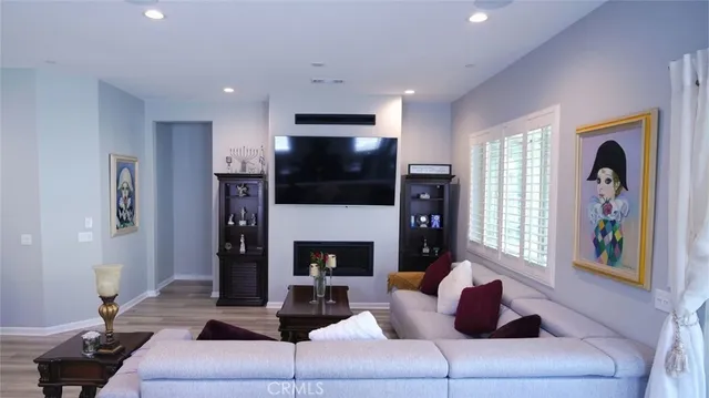 a living room with fireplace furniture and a flat screen tv