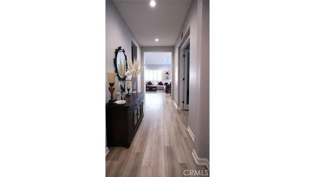 a view of a hallway with wooden floor