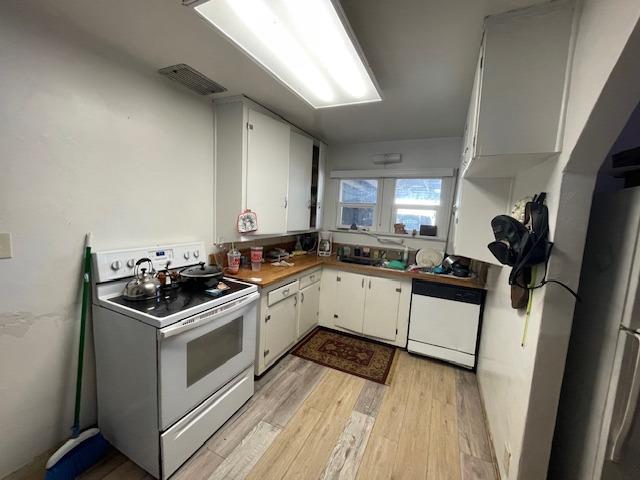 220 Little Avenue Gridley, CA 95948 - Photo 12 of 17 a kitchen with a stove and white cabinets