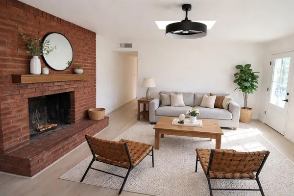 an empty room with a fireplace and windows