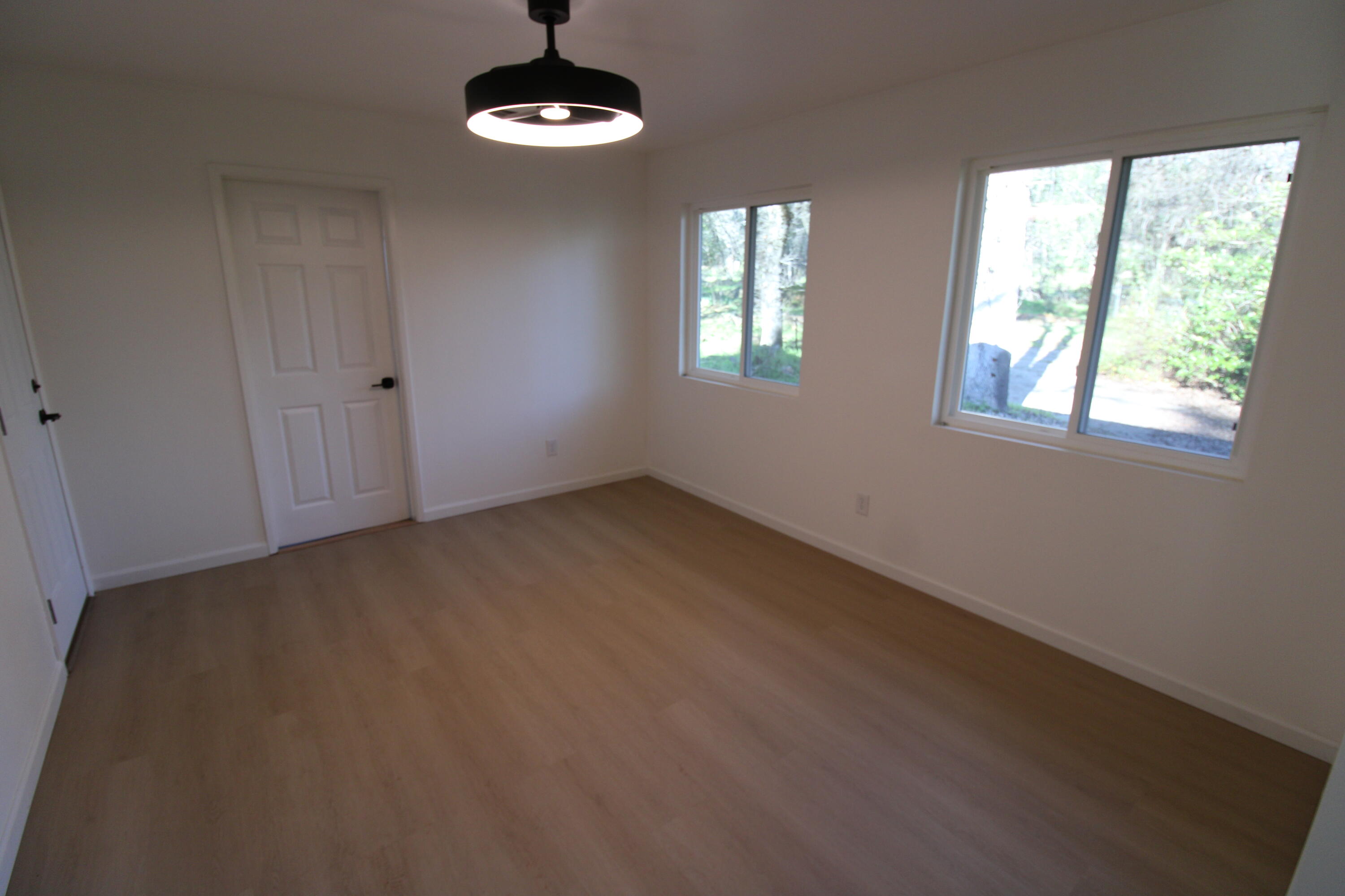 3170 Quartz Hill Road Redding, CA 96003 - Photo 22 of 68 an empty room with windows and chandelier fan