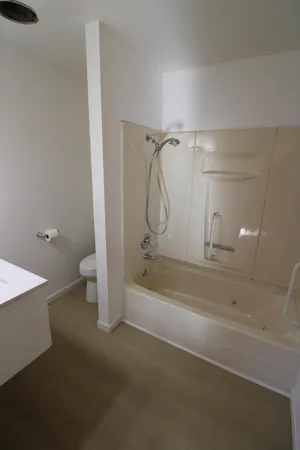 a bathroom with a sink toilet and mirror