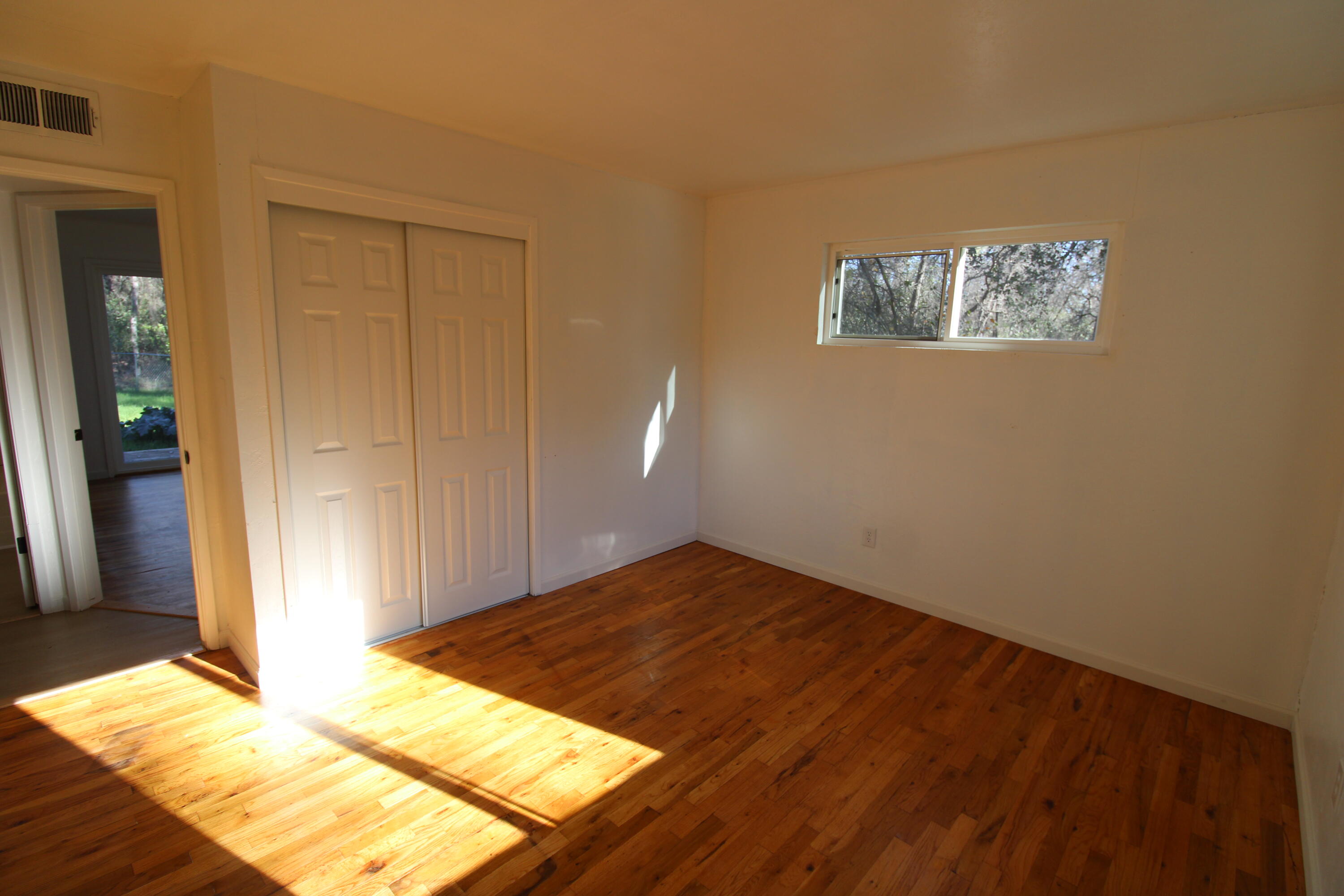 3170 Quartz Hill Road Redding, CA 96003 - Photo 36 of 68 a view of a bedroom with wooden floor and bedroom