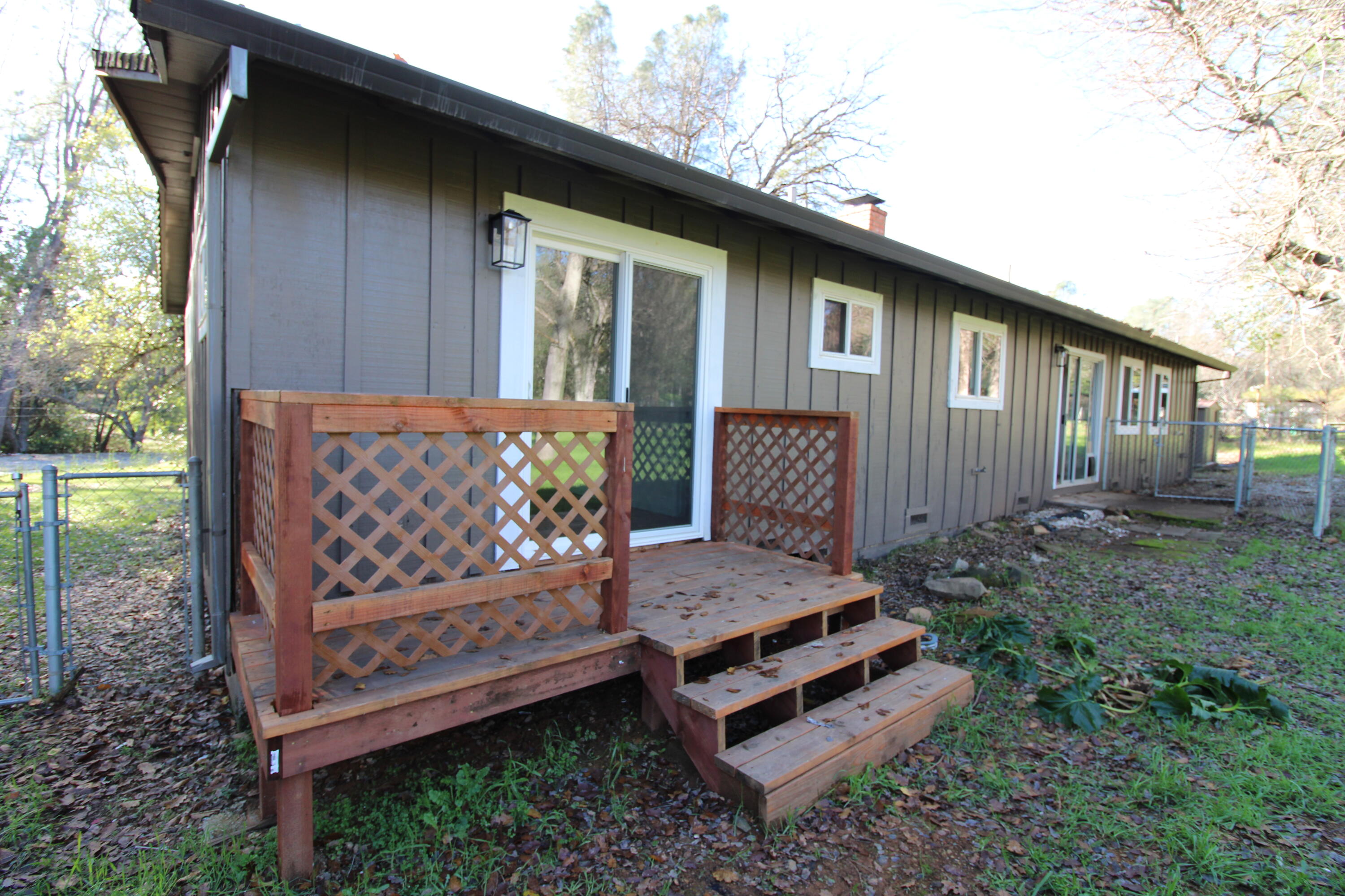 3170 Quartz Hill Road Redding, CA 96003 - Photo 4 of 68 a view of a wooden bench in back yard of the house