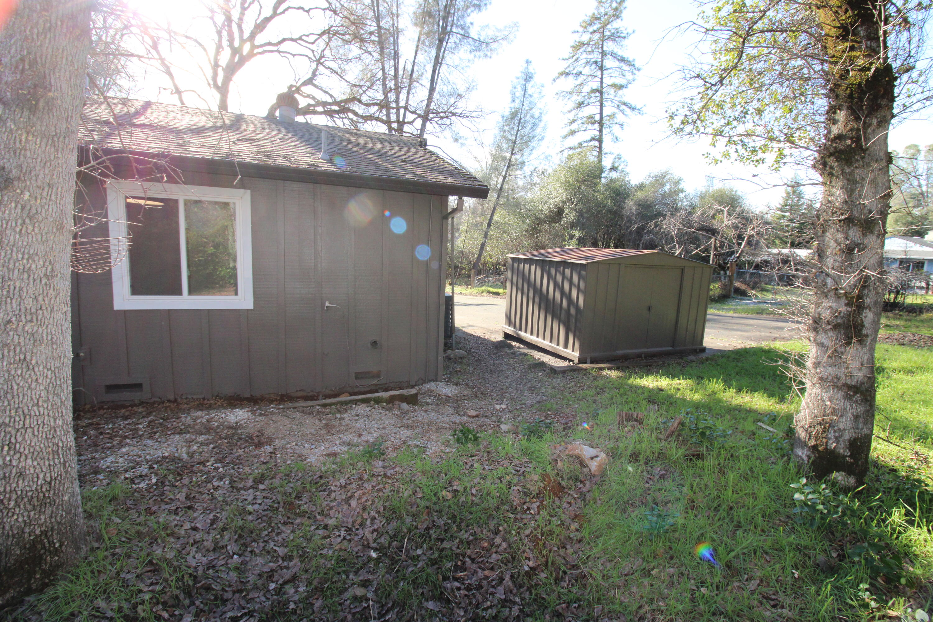 3170 Quartz Hill Road Redding, CA 96003 - Photo 64 of 68 a view of backyard with large trees and wooden fence