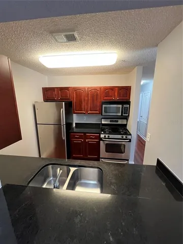 a kitchen with a sink and a refrigerator