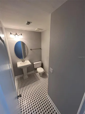 a bathroom with a toilet and a washing machine