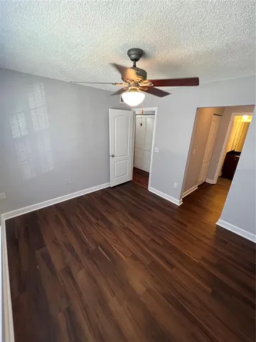 a view of a room with wooden floor and white walls