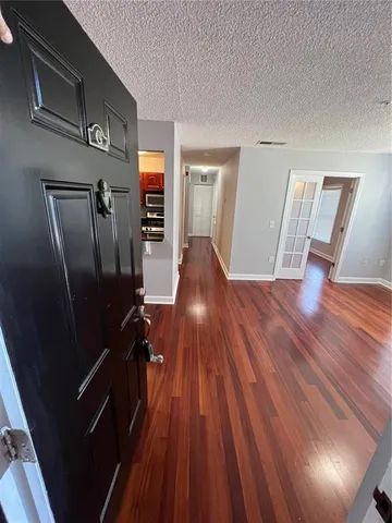a view of a livingroom with wooden floor and stairs