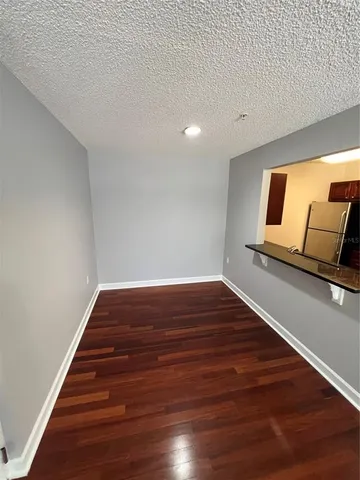 a view of room with wooden floor and stairs