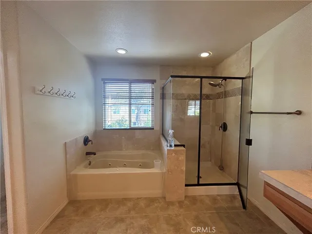 a bathroom with a bathtub and a shower