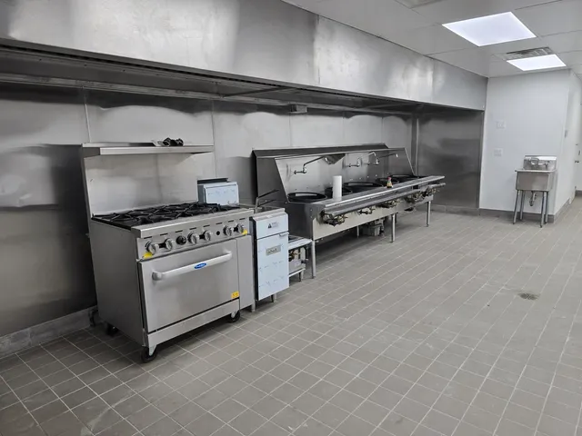 a kitchen with furniture and a stove top oven