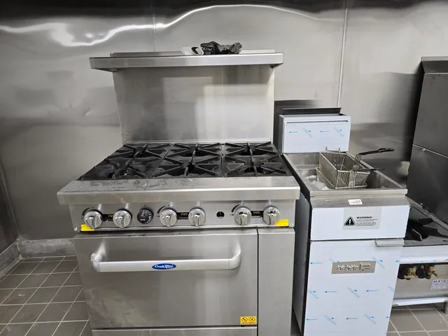 a white stove top oven sitting inside of a kitchen