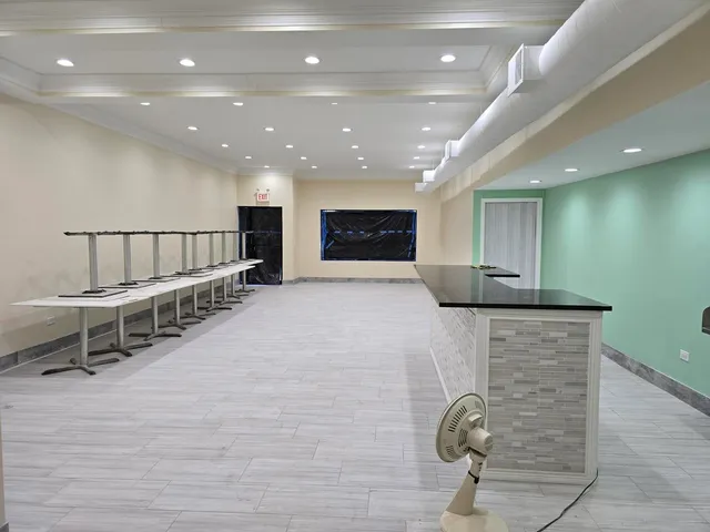 a view of kitchen with furniture and windows