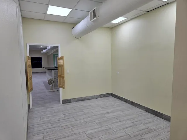 a view of a hallway and wooden floor
