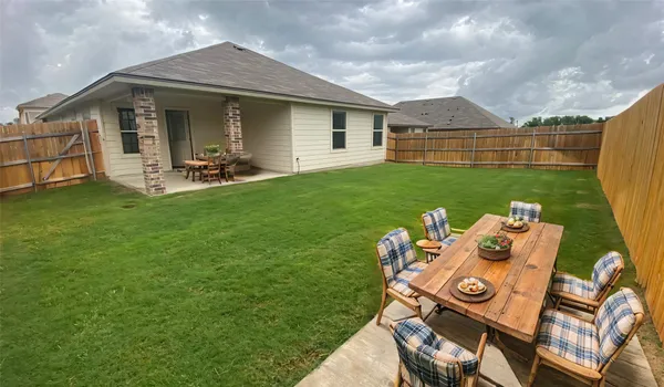 a view of a house with backyard and porch