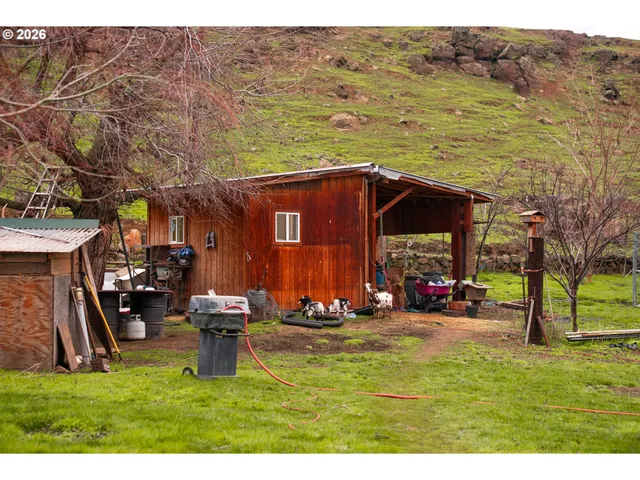 a bedroom with a bed and a flat tv screen on dresser