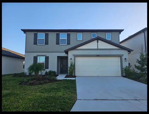 a front view of a house with a yard and garage