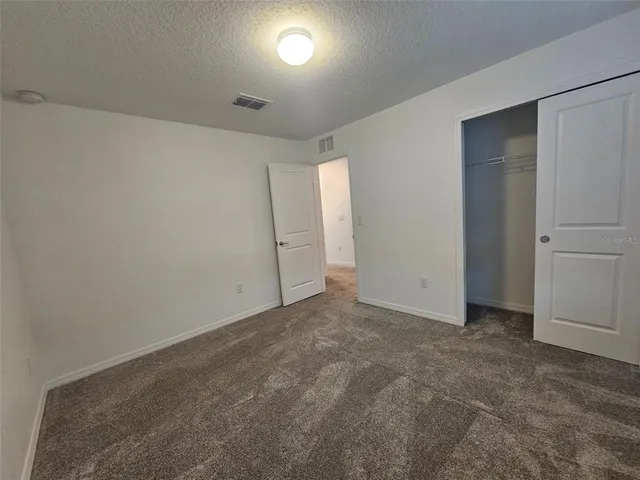 a view of an empty room and a window