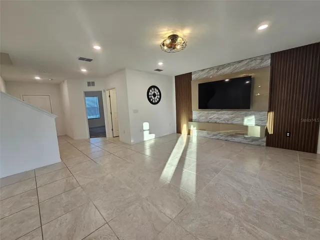 a view of a kitchen with kitchen island granite countertop a sink and a large window