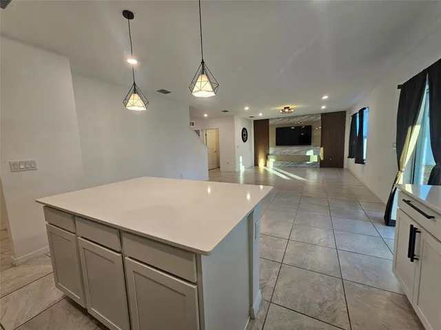 a kitchen with stainless steel appliances a stove a sink a microwave a refrigerator a stove a microwave and cabinets