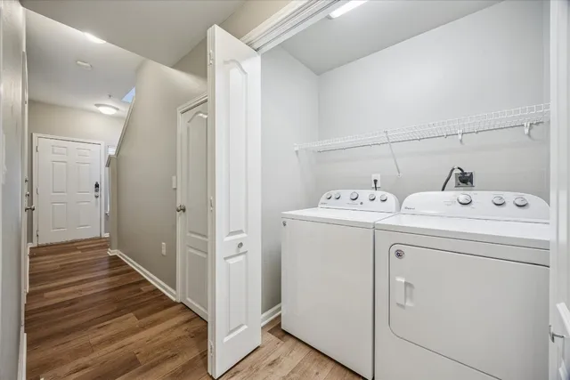 a utility room with cabinets washer and dryer
