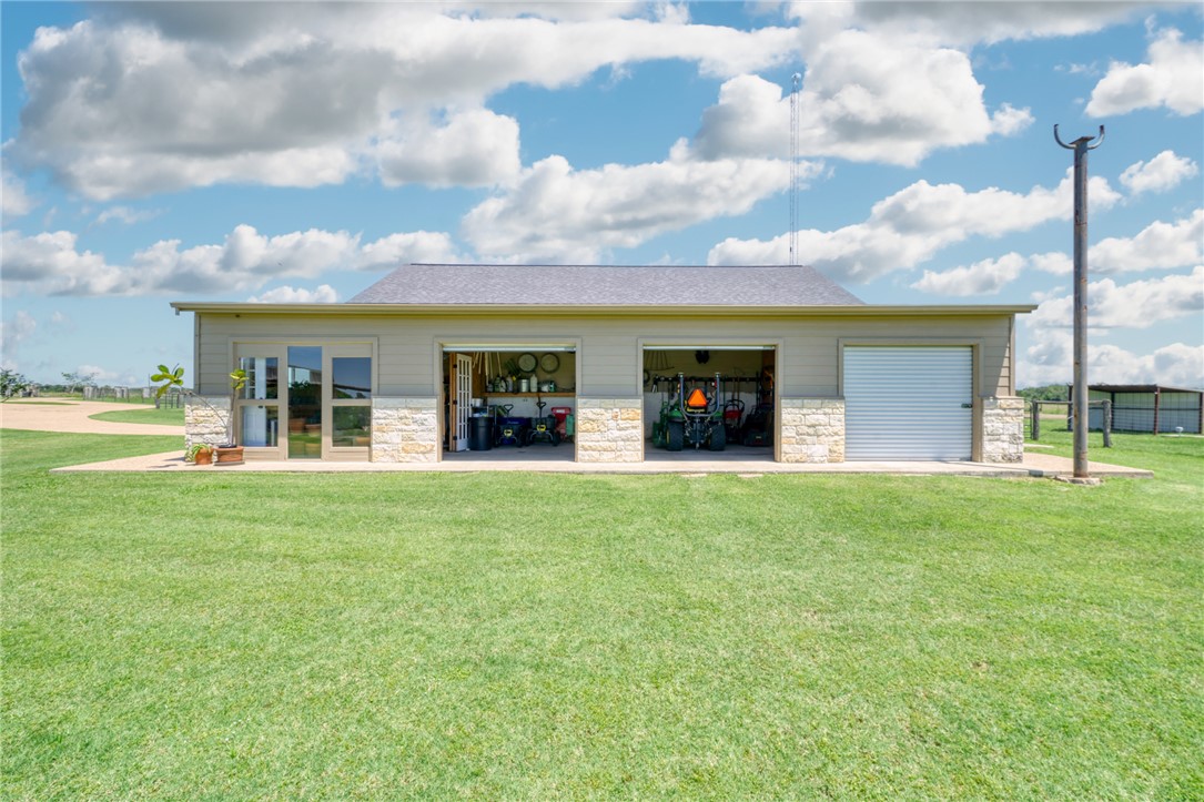 9652 Locke Road Bryan, TX 77808 - Photo 37 of 50 BACK VIEW OF SHOP AREA, LIVESTOCK CAPABILITY WITH ROOL UP DOORS