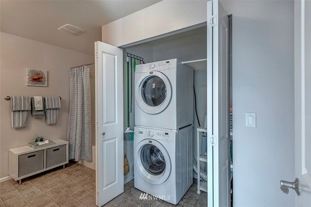 a utility room with sink dryer and washer