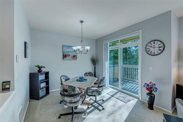 a view of a livingroom with furniture window and a chandelier